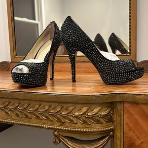 Black peeptoe high heels with black crystals.